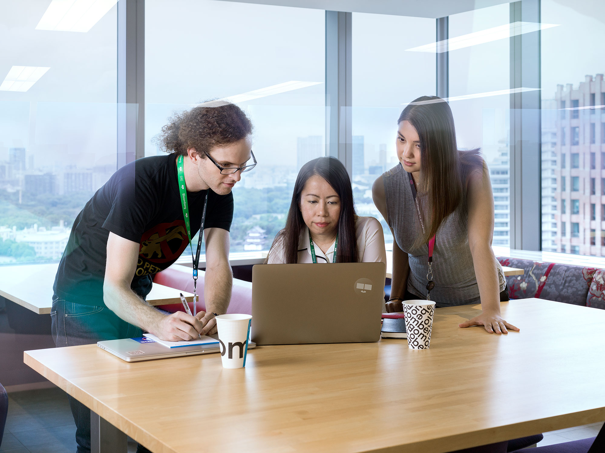 Department team huddled around laptop