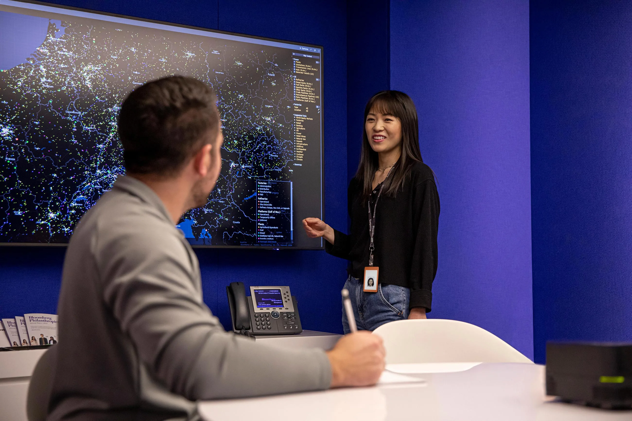 An employee presents to coworkers in a conference room at the New York offices.