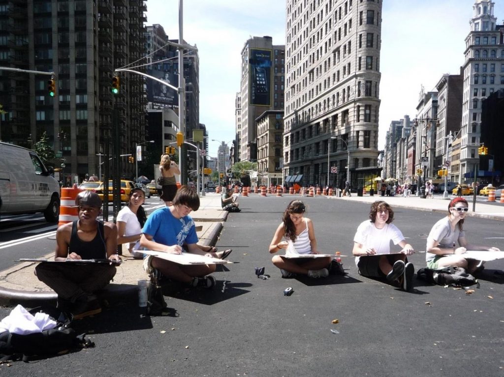 Art students sit on freshly-paved Broadway while construction continues around them to create the Flatiron/Madison Square Plaza in 2008.