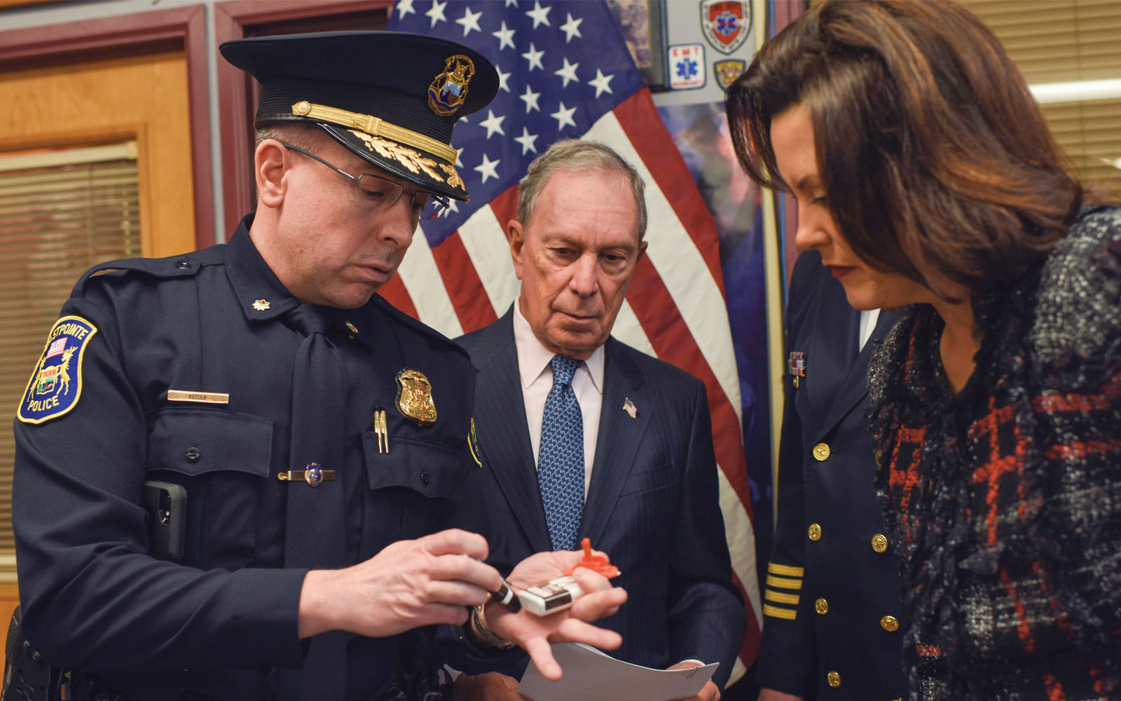 Deputy Police Chief Eric Keiser of Eastpointe, Michigan, demonstrates how to administer the overdose-reversing drug naloxone for Mike Bloomberg and Michigan Governor Gretchen Whitmer.
