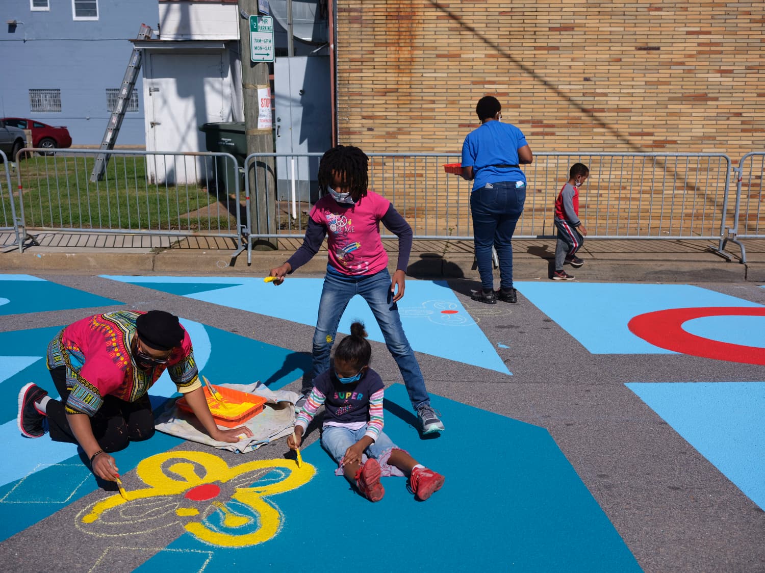 Kids paintings the intersection Asphalt Art, VA