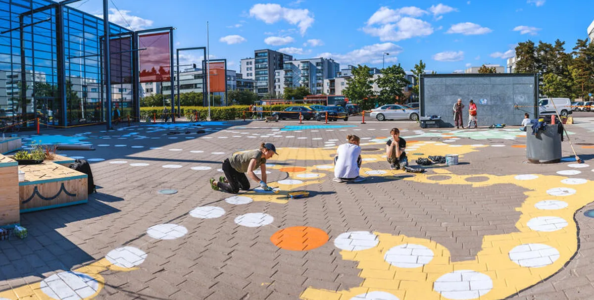 Activating a neighborhood plaza with an artful game - Helsinki, Finland