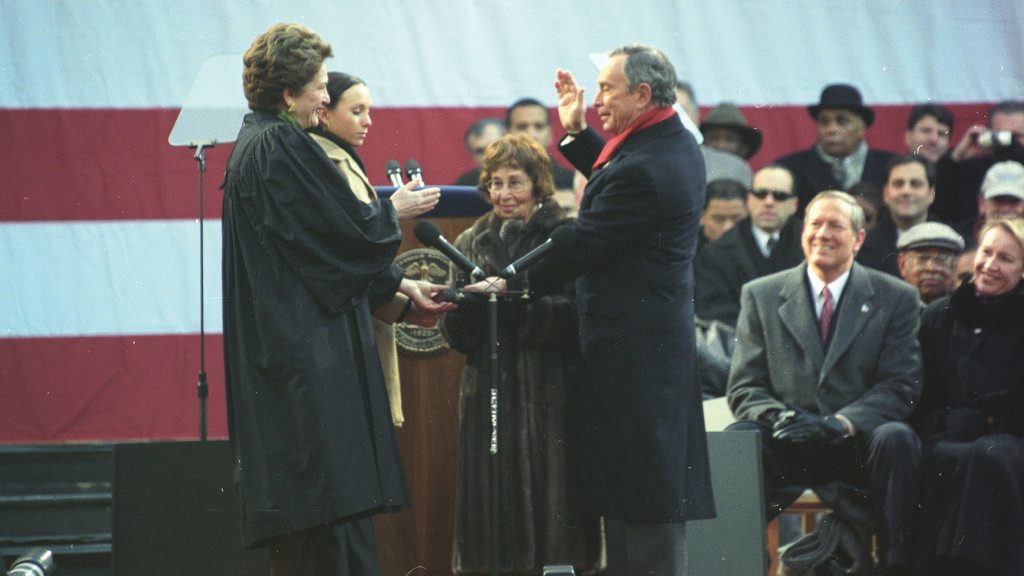 Photo of Mike Bloomberg being sworn into office on a Bible held by his mother.