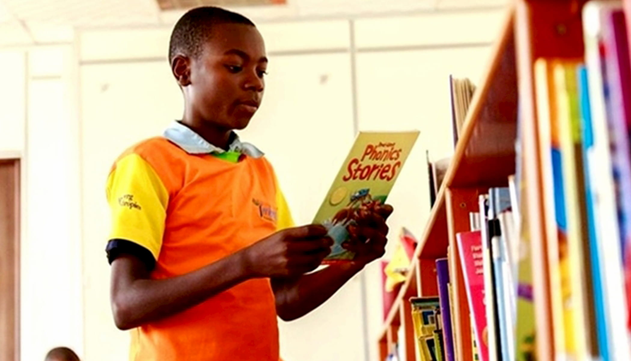 A student reading books at the launch of the Library for All mobile app in Kigali, Rwanda.