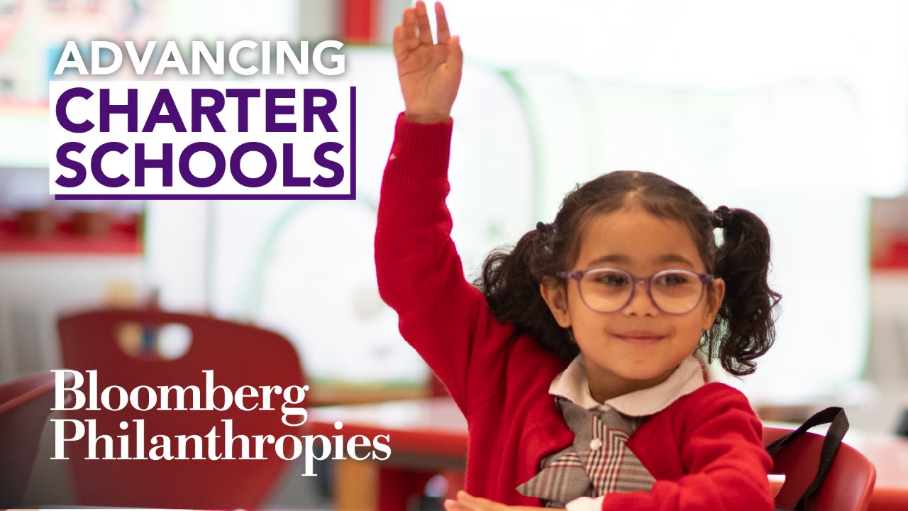 A school girl raising her hand to participate in advancing charter schools