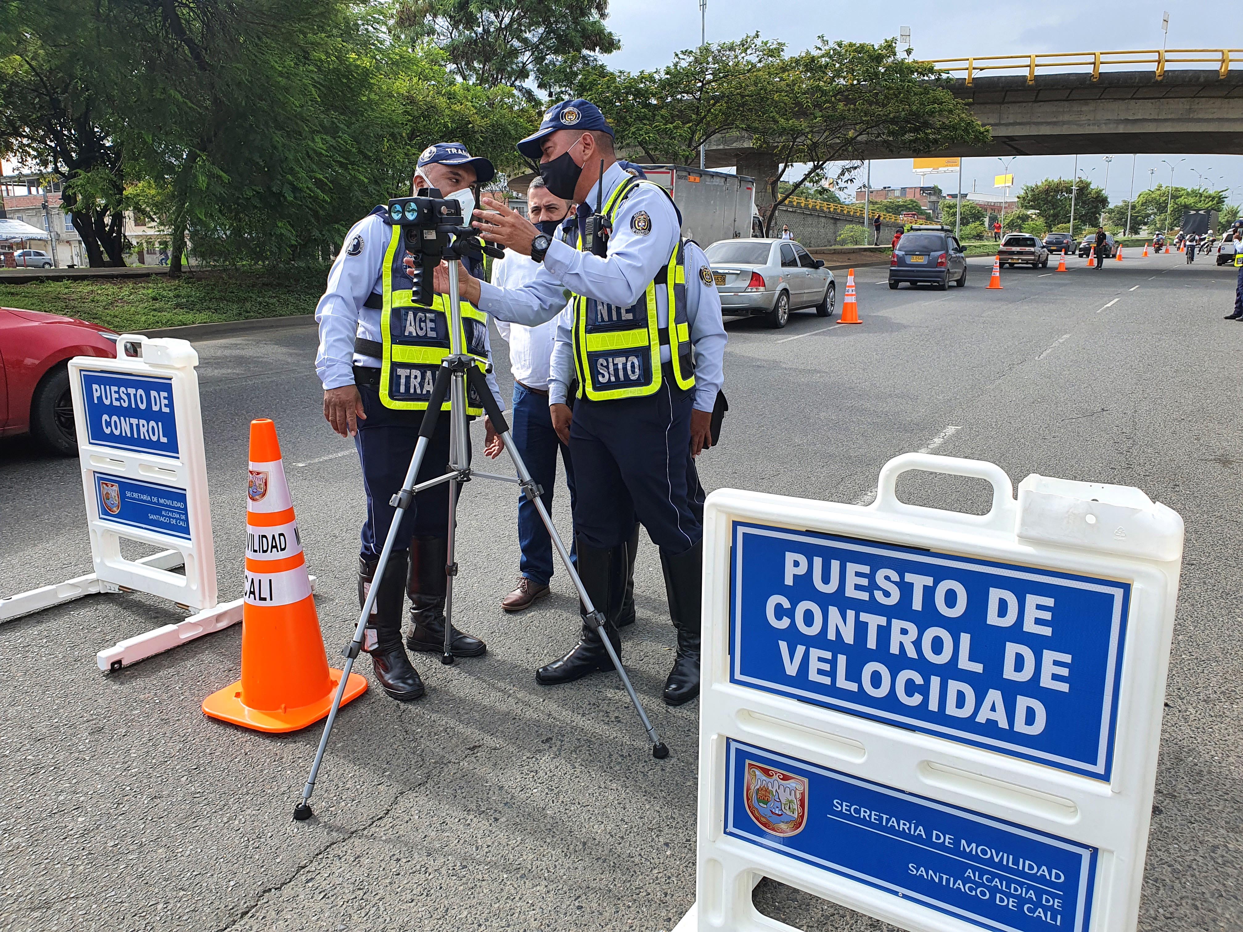 Three officers supporting national road safety law in Colombia