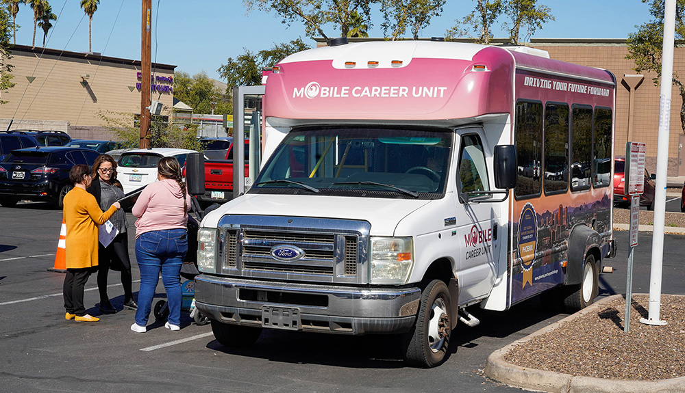 Job seekers access job search services through a mobile career van for people without internet access.