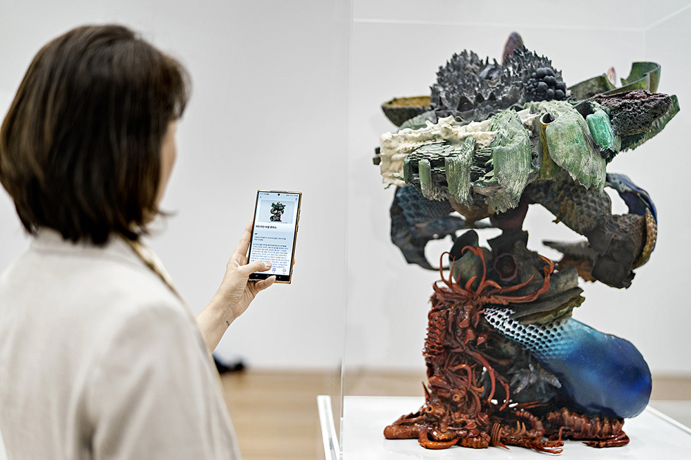 A visitor at the Mori Art Museum in Tokyo uses the Bloomberg Connects to explore Adrián Villar Rojas’ Untitled 22 installation.