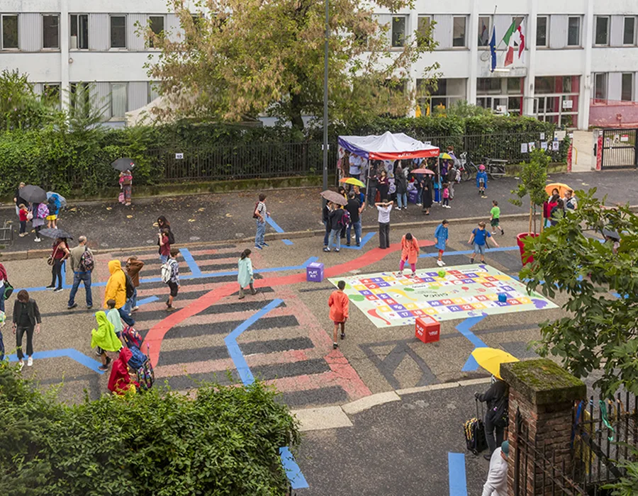 Streets near schools in Milan transform into safe play spaces for families through the Play Places initiative.