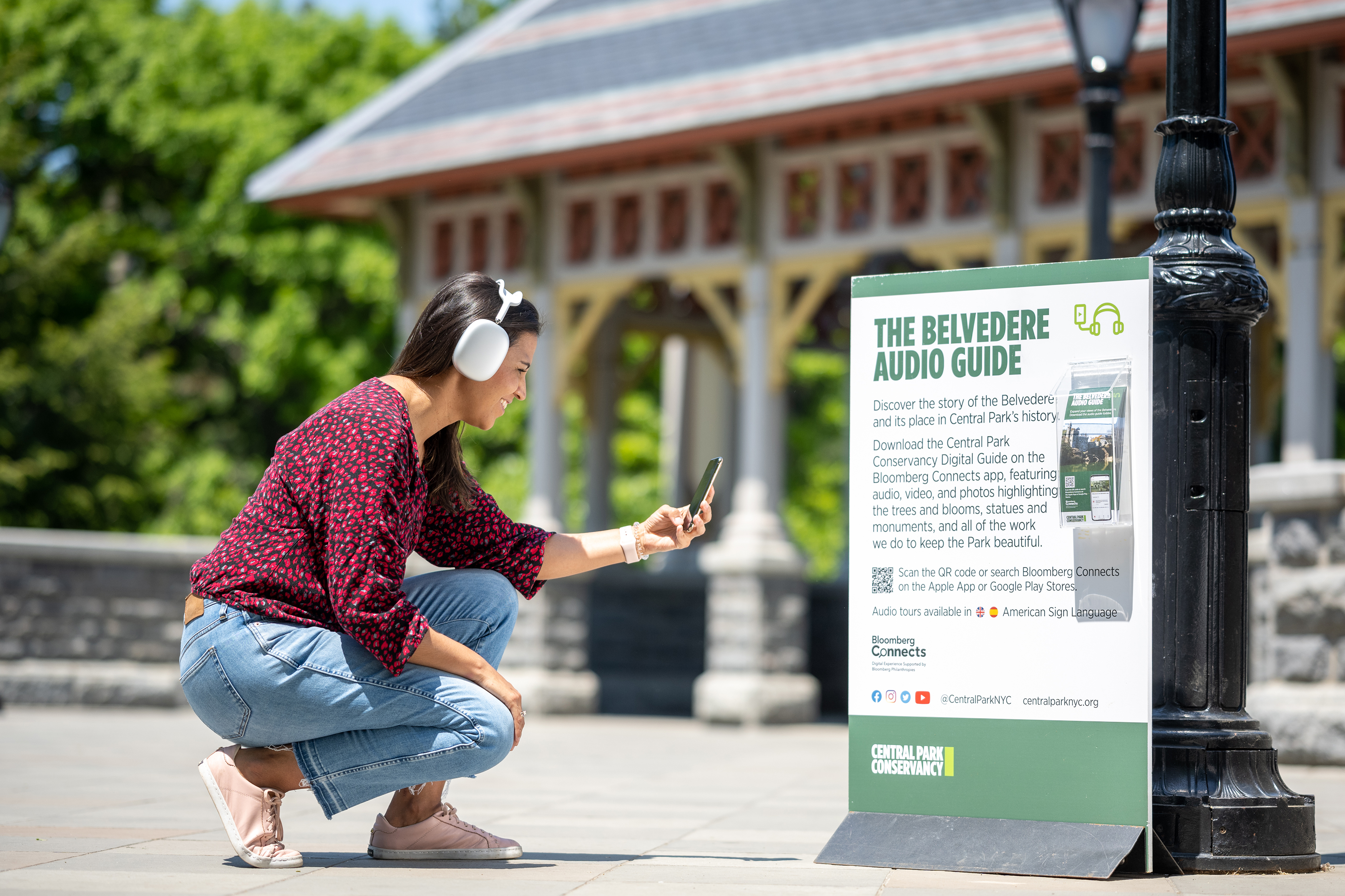A women scanning Bloomberg Connects qr code