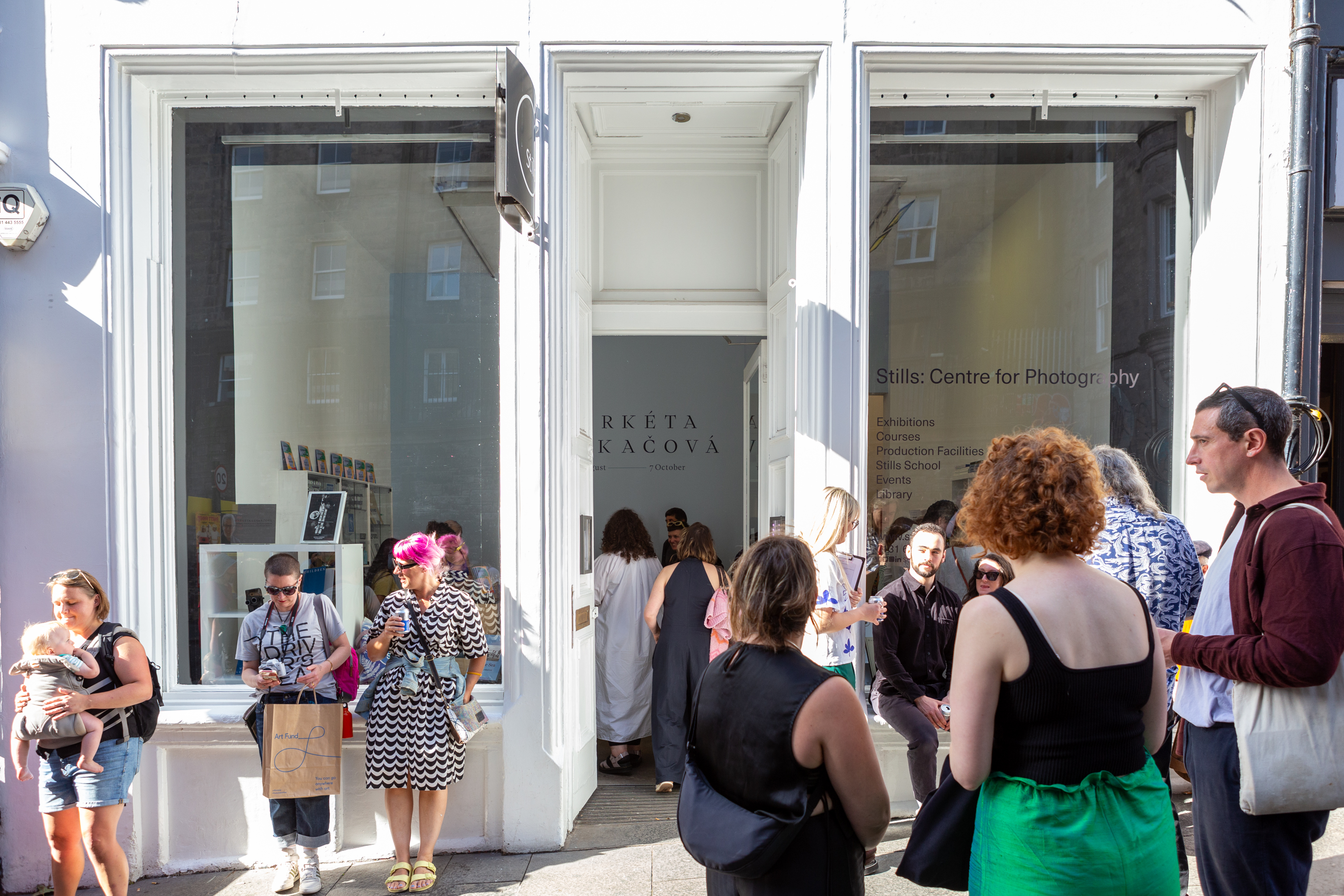 Exterior of Stills: Centre for Photography surrounded by people attending an event there.