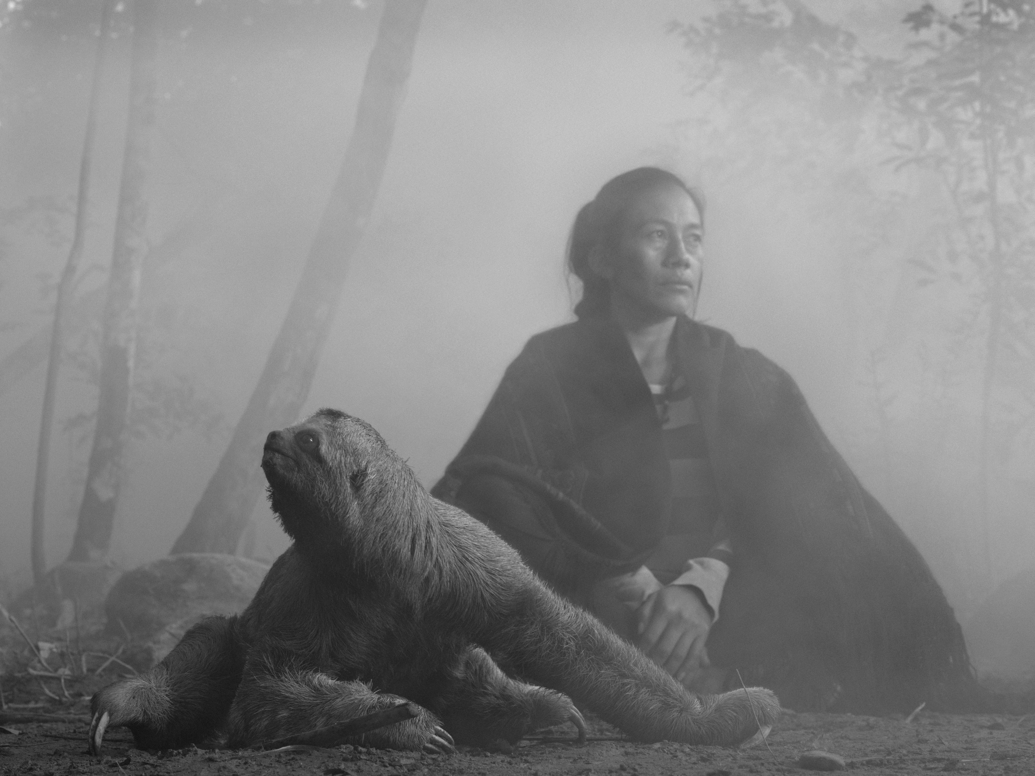 Bolivian woman sitting next to rescued sloth
