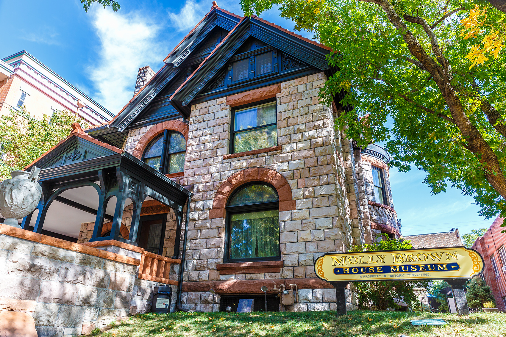 Exterior of Molly Brown House Museum, a three-story tan stone house with dark trim.