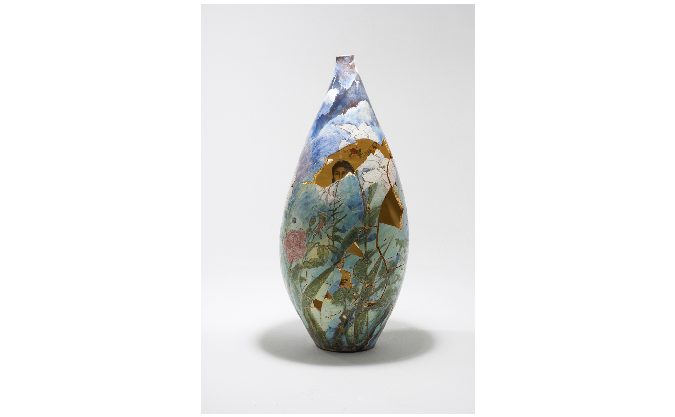 Ceramic vase with a floral exterior and shards missing