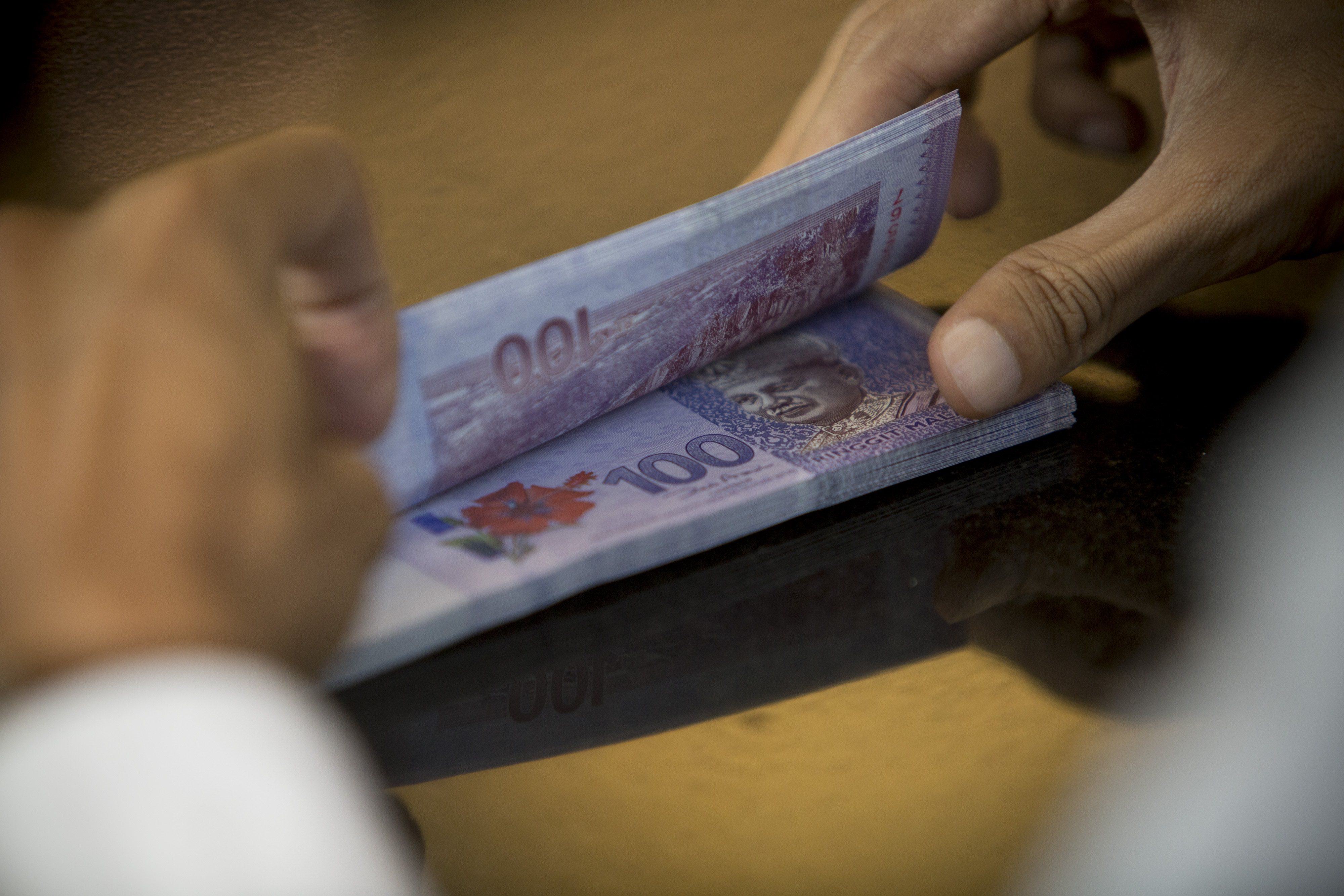 Malaysians borrow more from abroad as risk rises, ringgit falls