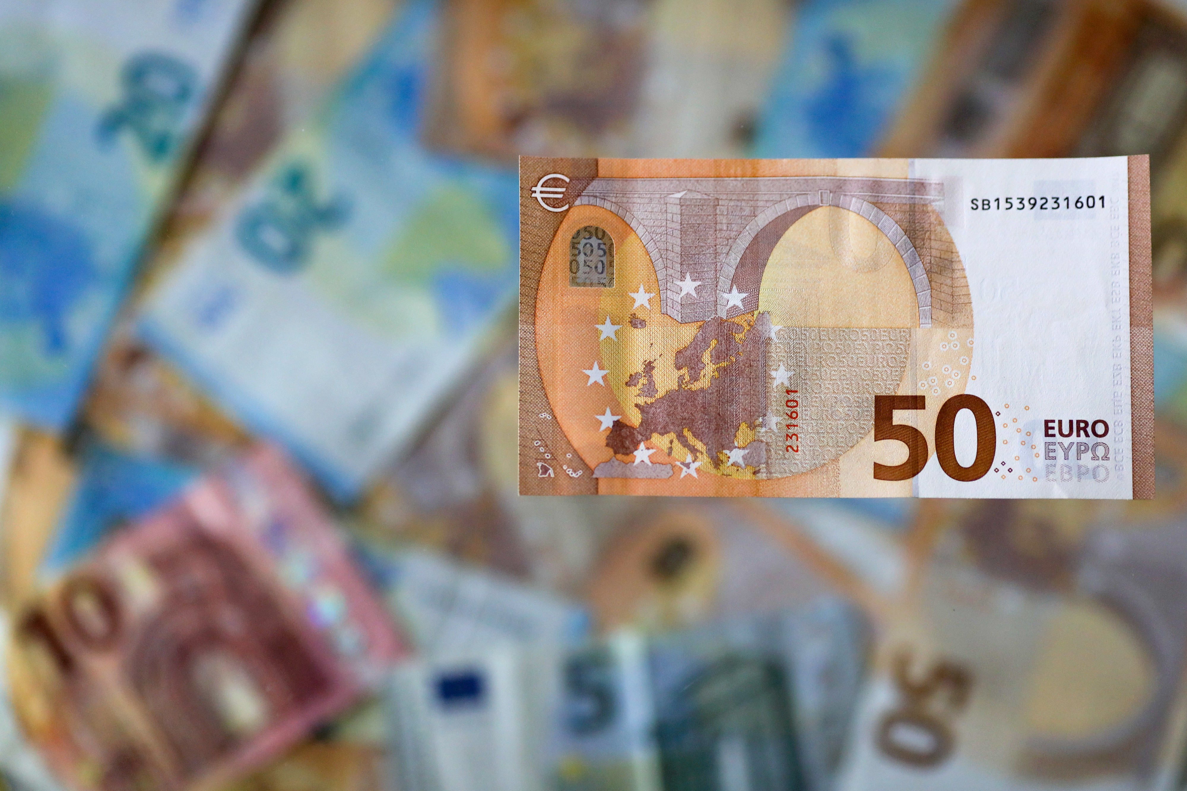 A 50 Euro banknote against a background of Euro banknotes