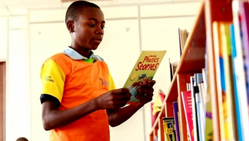 A student reading books at the launch of the Library for All mobile app in Kigali, Rwanda.