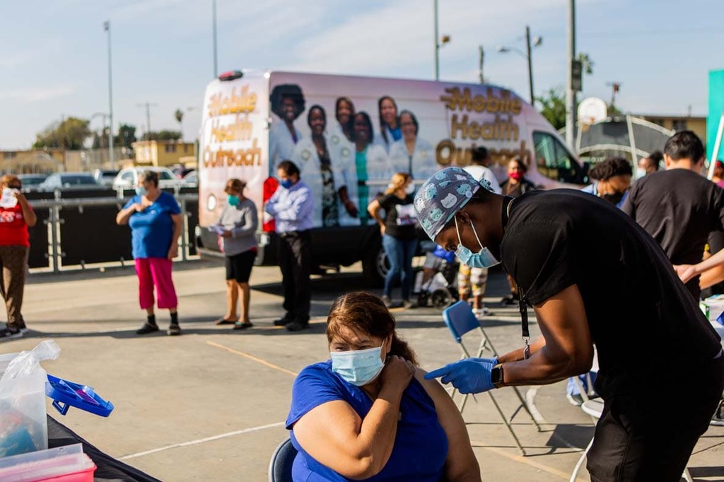 A resident of Los Angeles, California, receives a vaccination against COVID-19 at a mobile unit run by Charles R. Drew University of Medicine and Science and supported by Bloomberg Philanthropies.