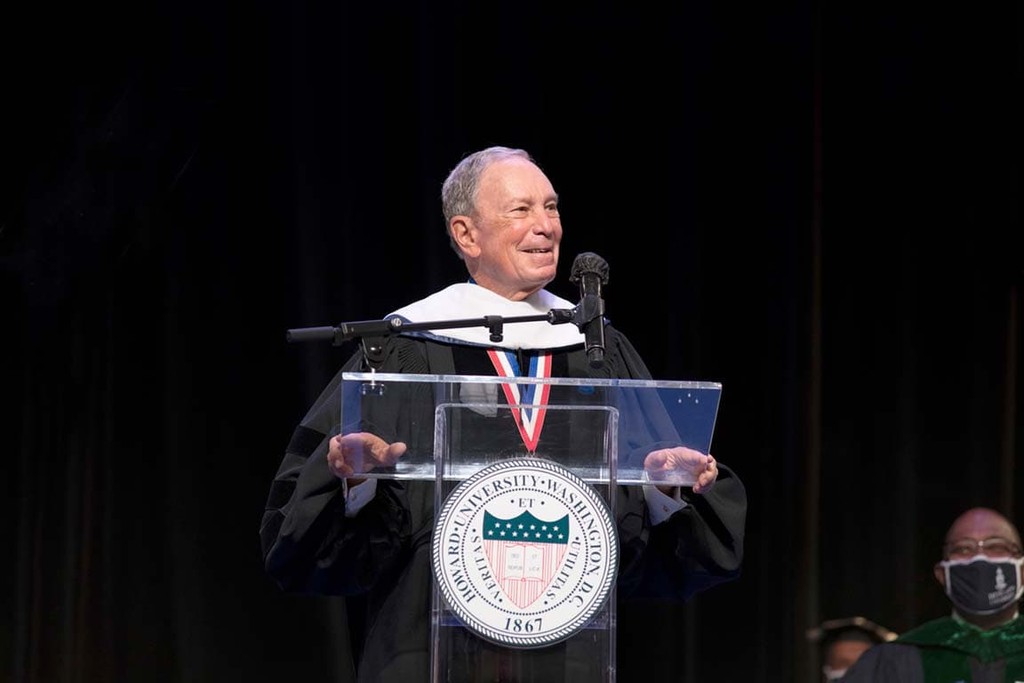 Mike Bloomberg stands at the podium at Howard University and delivers commencement remarks.