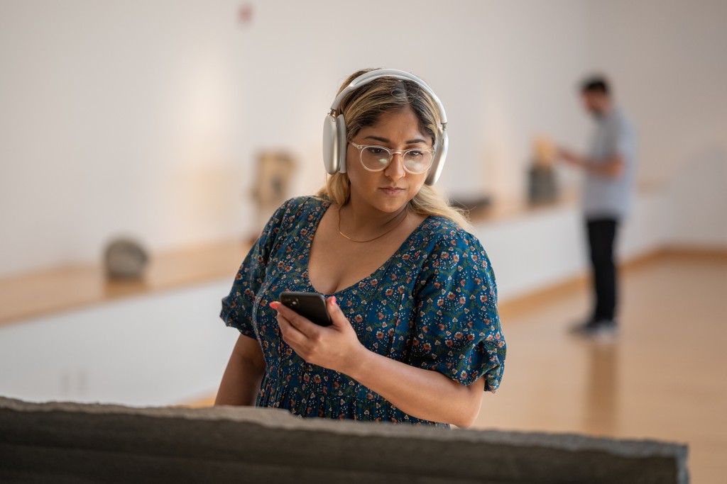 Young lady immersed in the Bloomberg Connects app