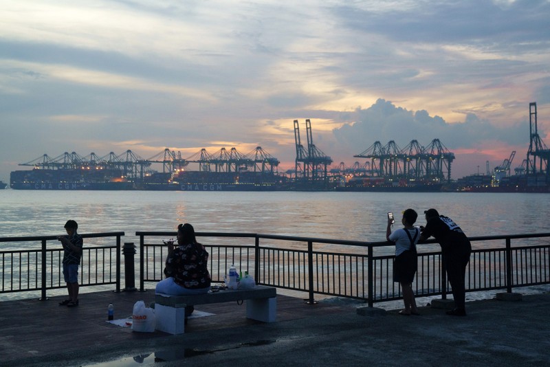 Gantry cranes at the Pasir Panjang terminal in the background. Singapore’s goal is to make the port more efficient for ships to carry out all their needs.