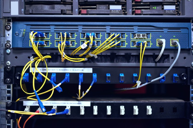 Data center, cables and hardware in control room for information technology, configuration or software update.