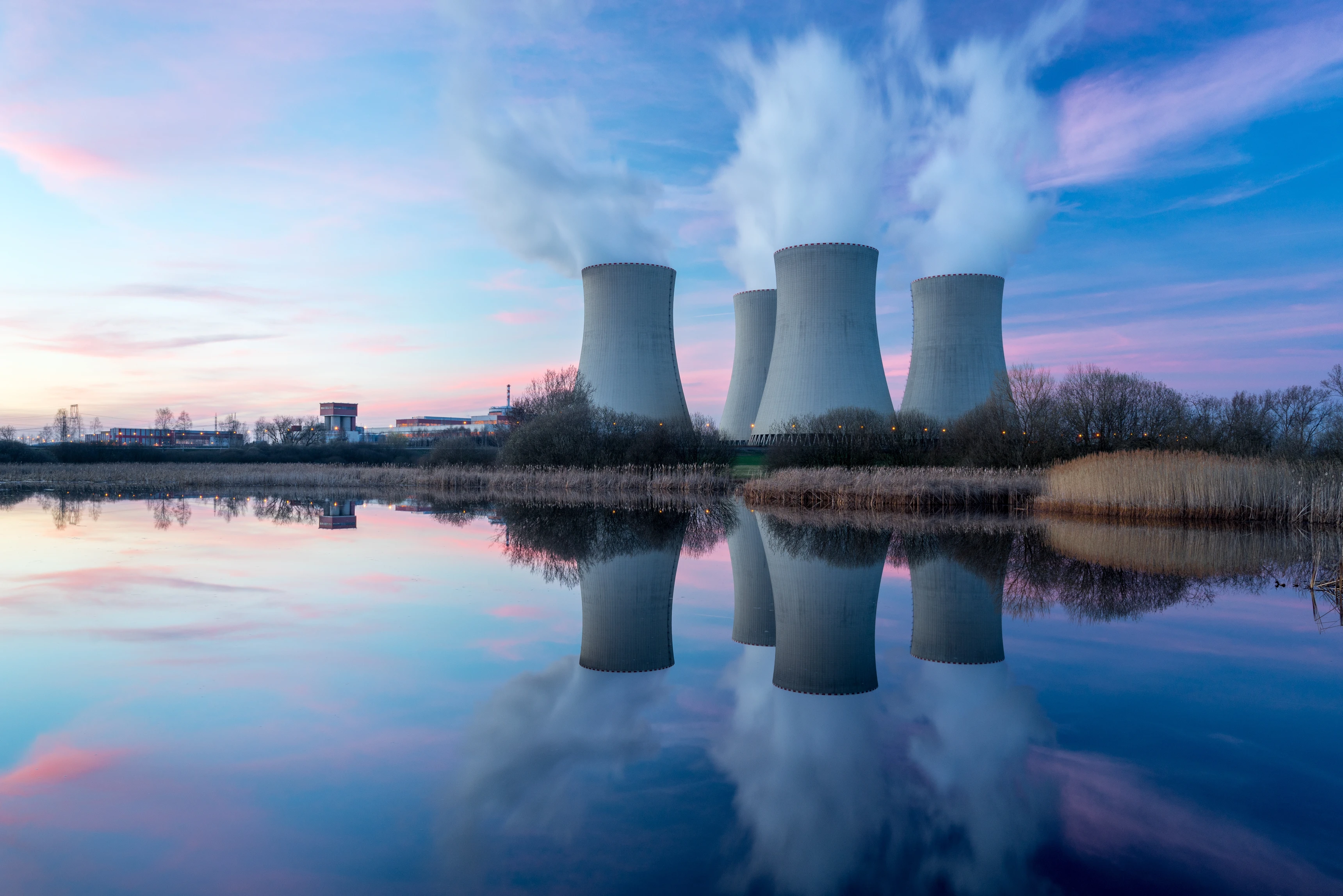 Nuclear power plant against sunset