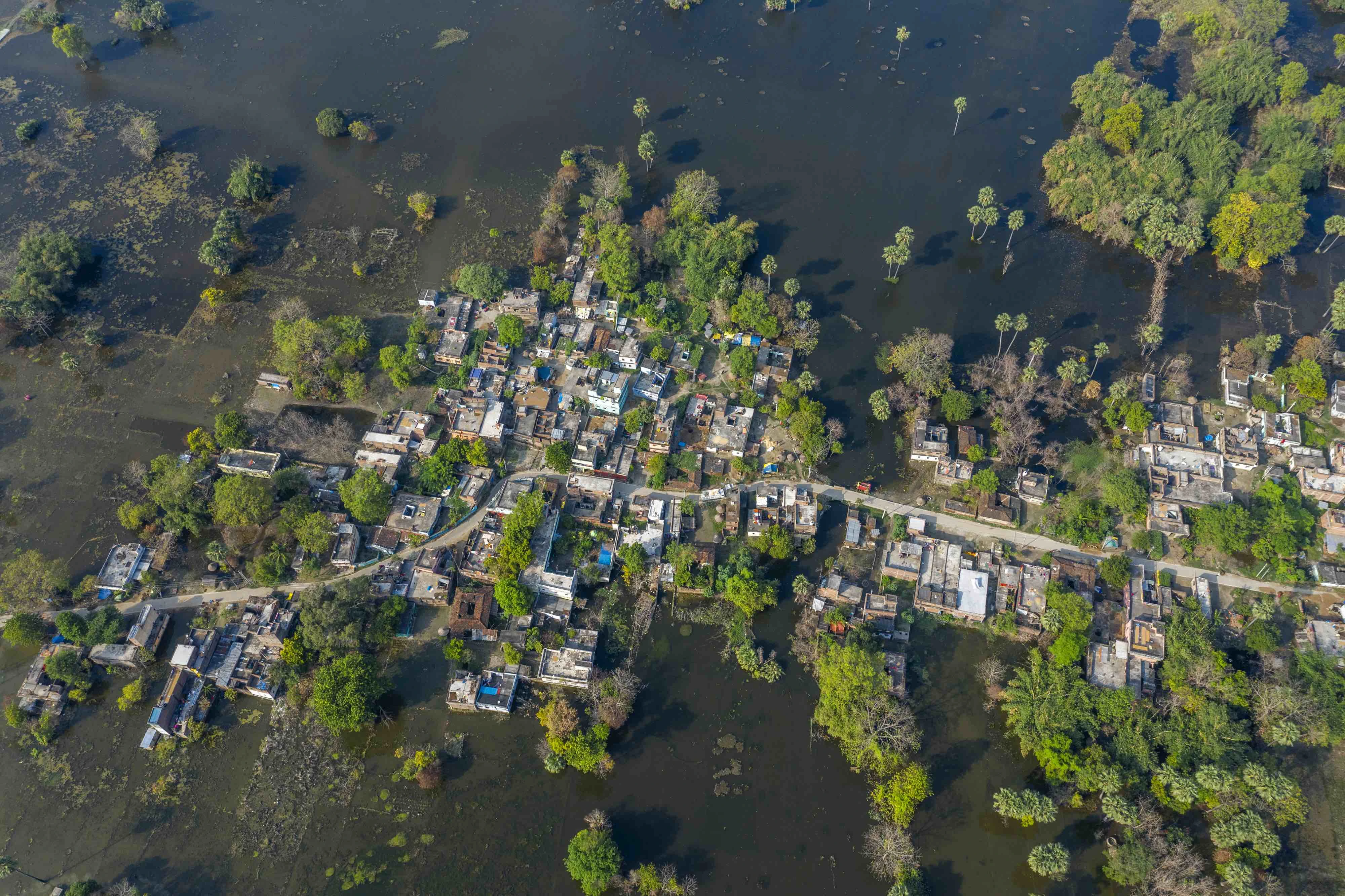 Flood water surrounds buildings and land