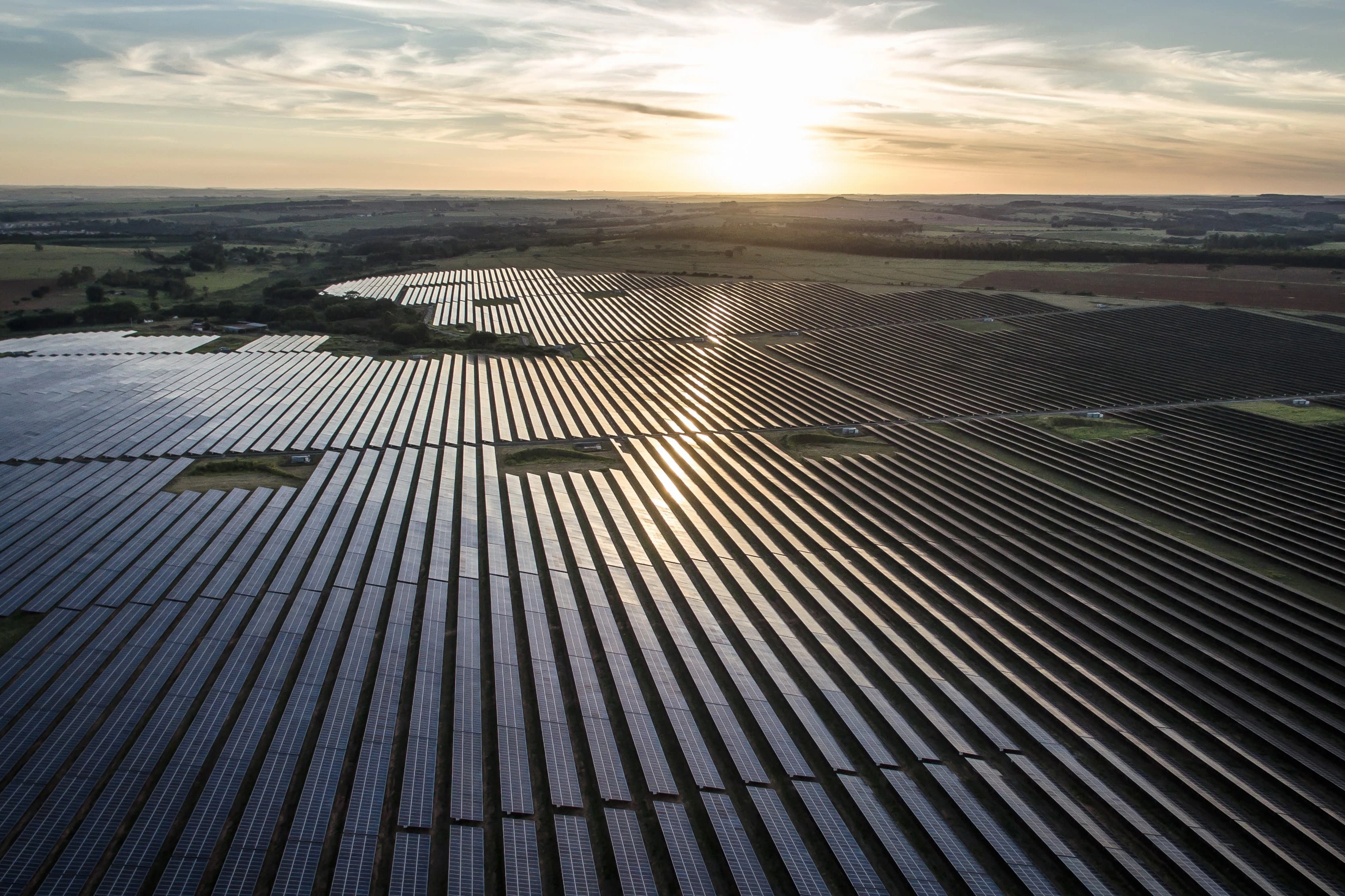 Sunlight reflected on photovoltaic modules on a solar farm.