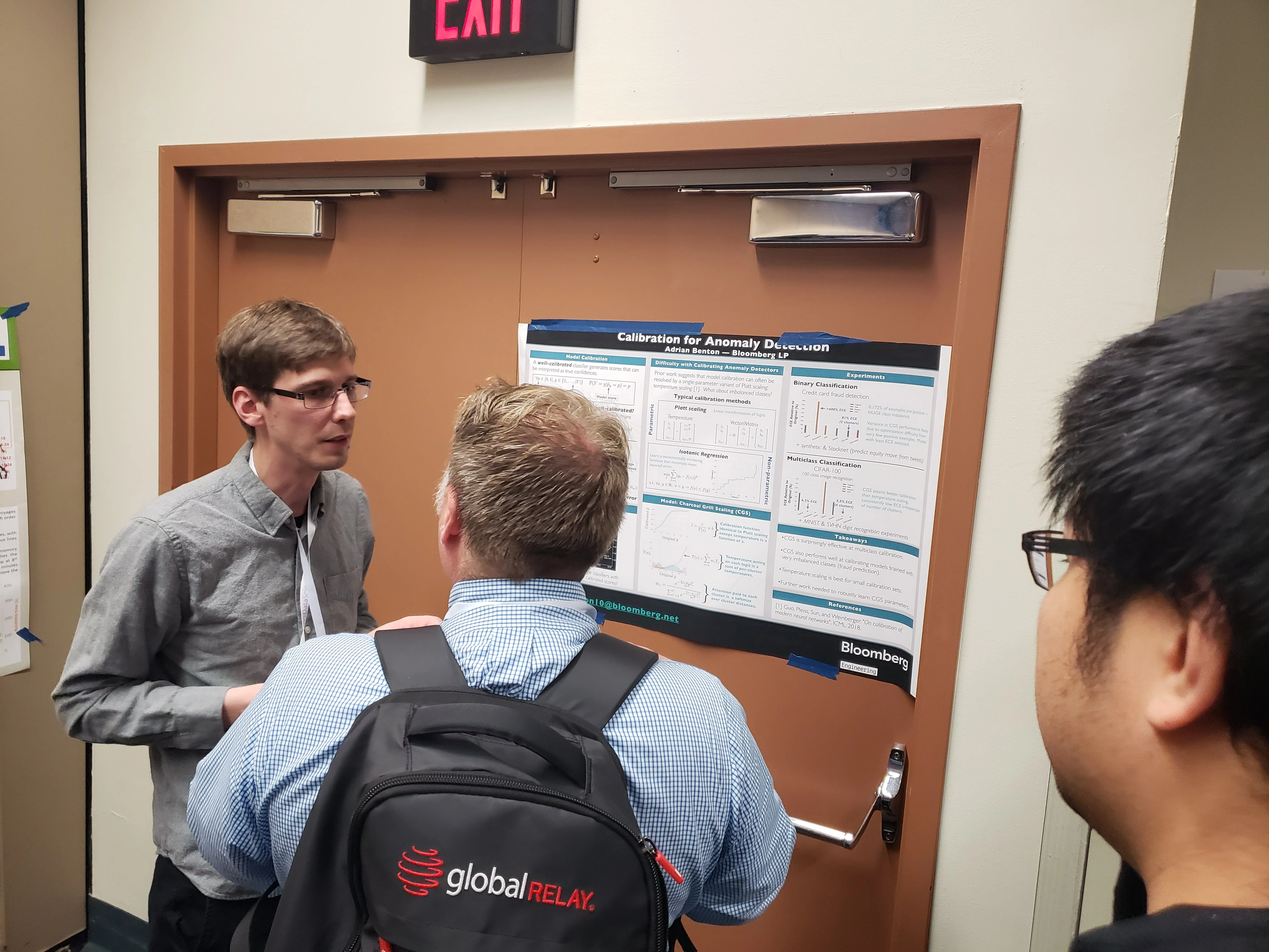 Senior Research Scientist Adrian Benton talks with workshop attendees about his “Calibration for Anomaly Detection" research