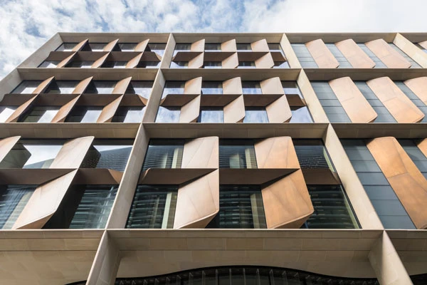 Bloomberg_LDN_Exterior_06_Facade When the outside air temperature is suitable, we can turn off our mechanical ventilation system, open the custom bronze blades shading the building’s interiors and cool the building with naturally flowing air. This significantly reduces energy consumption.