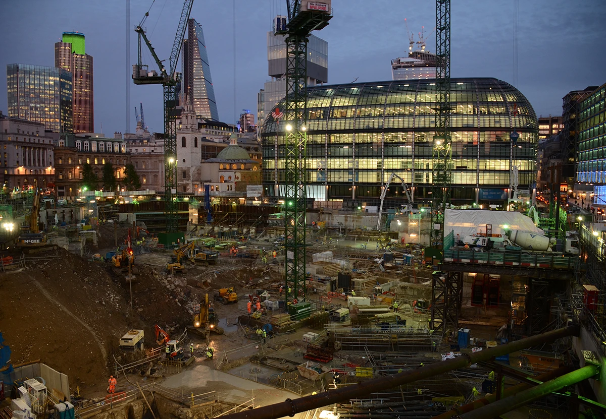 The Bloomberg site under construction at night.