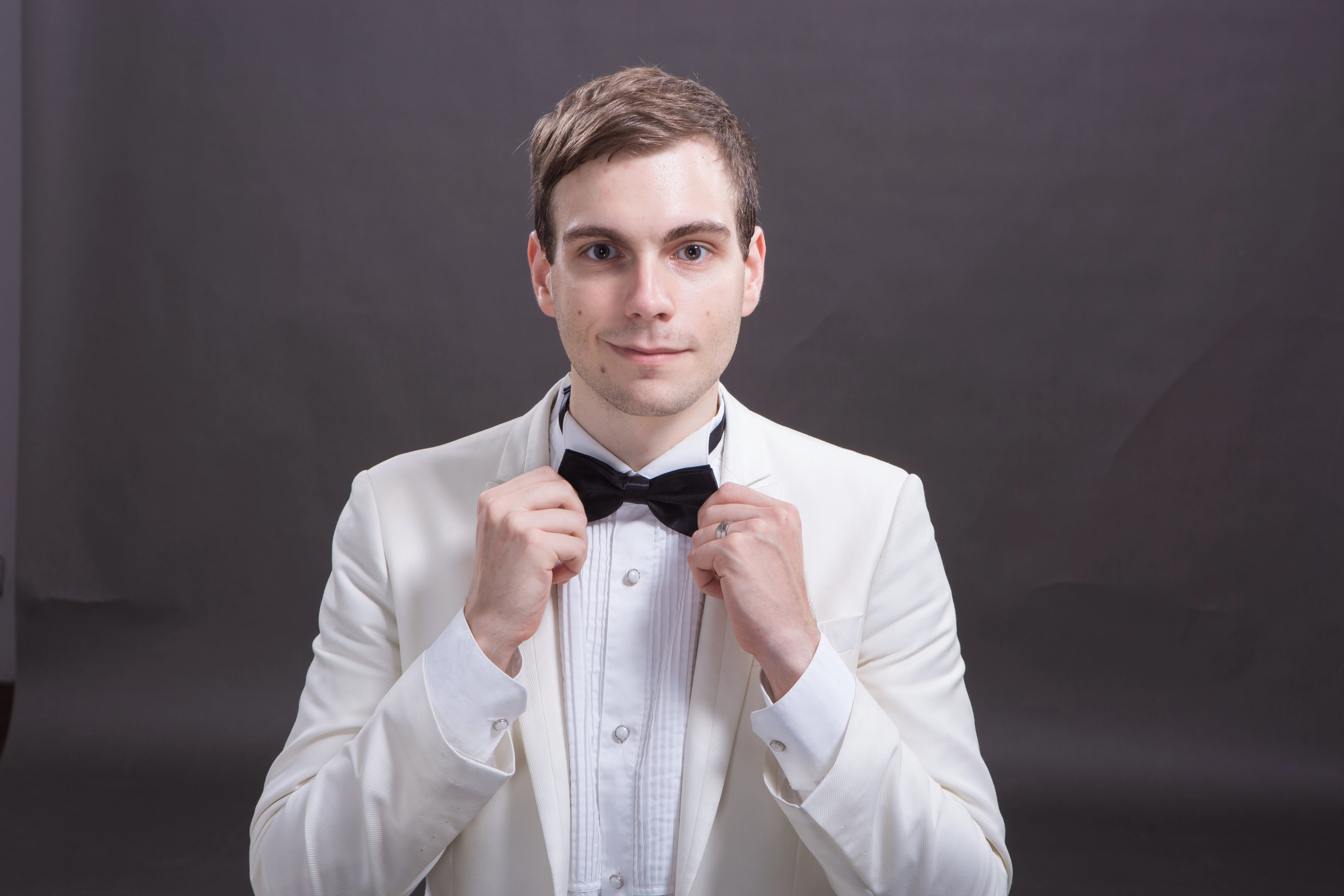 Spencer Carver wearing a white tuxedo and black bowtie