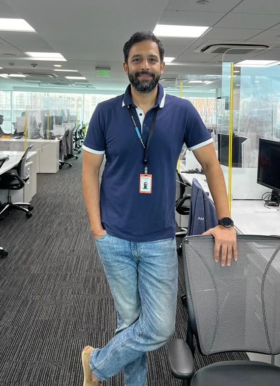 Rohit Bhalerao standing next to a desk in the Pune office.