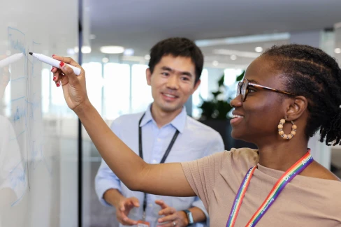 Corporate-Functions-department Two marketing employees brainstorm their next campaign